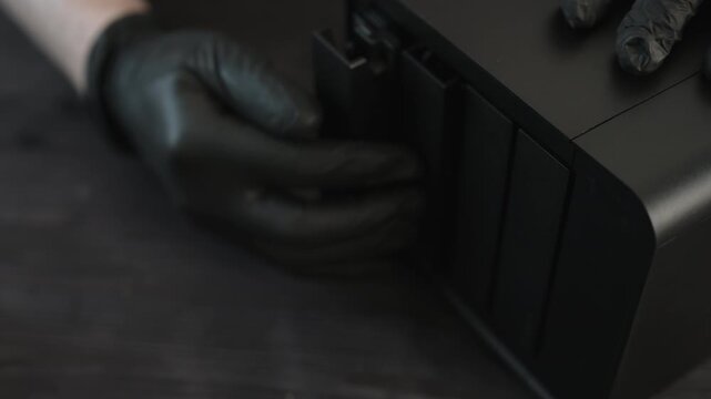 Service Technician In Gloves Closes Hard Drive Bays On A Desktop Nas Server During Storage System Maintenance In Service Center