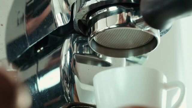 close up of coffee machine,Fresh espresso coffee pouring from professional coffee machine into white cup in cafe.