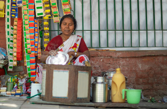Old woman making tea on a roadside tea stall (Common people) 