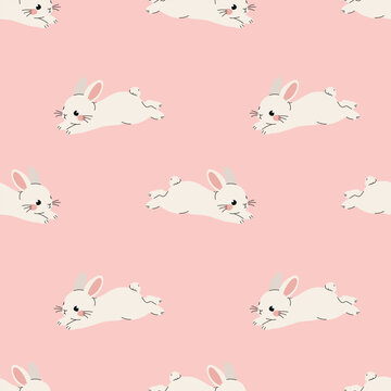 Seamless pattern with cute white bunnies lying on light pink background. Sweet lying rabbit animal surface print for kids apparel nursery decor bed linen and baby wrapping paper.