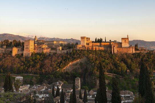 Alhambra on the Sabikah hill at sunset, Moorish citadel, Nasrid palaces, Palace of Charles the Fifth, behind Sierra Nevada with snow, Granada, Andalucia, Spain