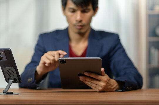 Professional Businessman Using Tablet at Desk in Office Environment