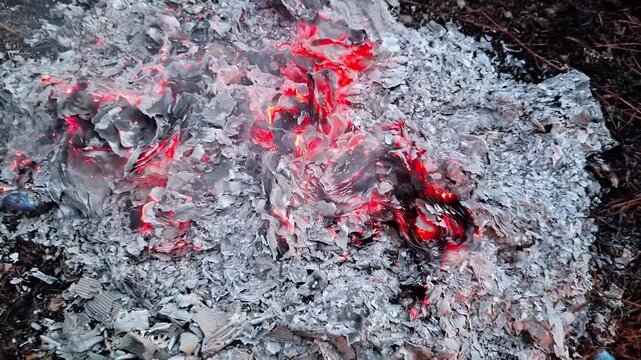 Embers from burning waste paper