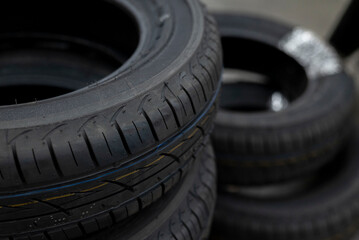 Stacked new car tires in automotive workshop © virginia