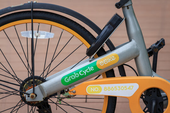 oBike and GrabCycle logo on sharing bike parked on footpath in Singapore, GrabCycle is Grab and oBike co-branding, provide a bike sharing service in Singapore