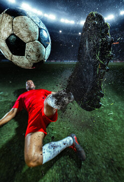 Football player performing bicycle kick with muddy boot and ball dominating foreground. Concept of spectacular scoring, professional match excitement, dynamic sports poster.