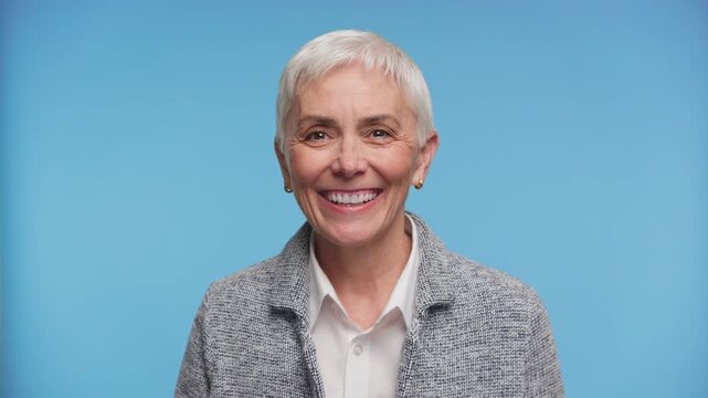 Senior Woman Greeting Someone During Video Call