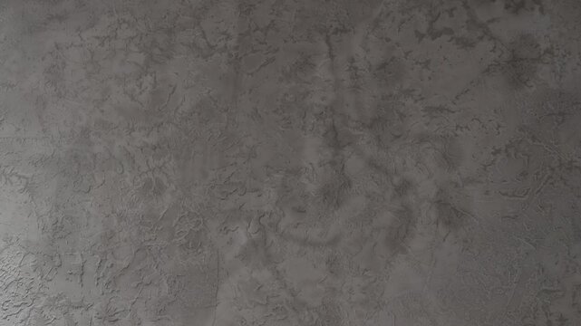 Mystical Moving Chandelier Shadows on Textured Gray Wall. Elegant Abstract Light Background. 4K. Soft moving shadows cast by an elegant crystal chandelier create a mysterious atmosphere
