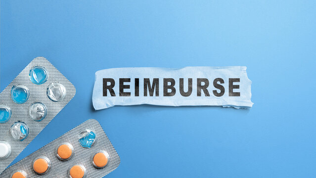 Flat lay of the word "REIMBURSE" on torn paper with pill blister packs on a blue background, representing medical cost refund. Concept of Reimburse
