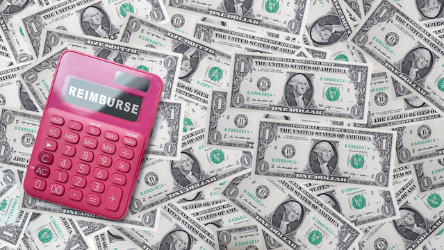 Pink calculator showing 'REIMBURSE' on its screen placed on a background of scattered US one-dollar bills, representing financial refund and expense tracking. Concept of Reimburse