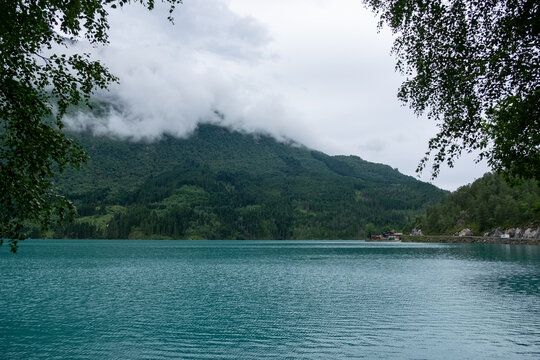 Turquoise Oldevatnet Lake with Misty Mountain Backdrop in Vestland Norway