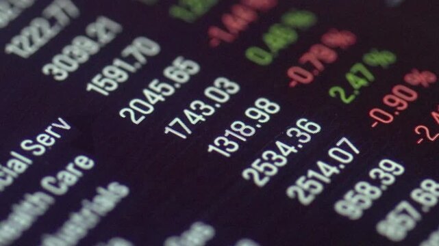 Close-up device screen with stock market data and trading information, charts, prices up and down. Trading board, investment decision, equity, financial market, growth, risk, strategy. 