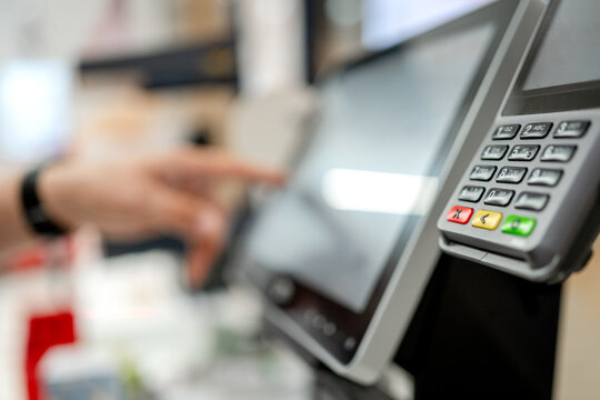 Customer using point of sale terminal in retail store