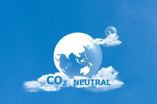 Carbon neutral letters and icons on blue sky background.