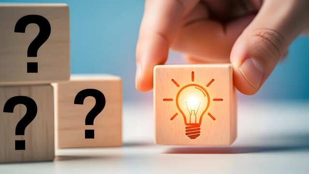 Hand holding cube with light bulb icon solving problem and finding solution among question marks.