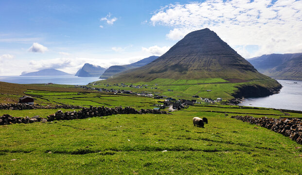 Mountain scenery with the majestic Malinsfjall mountain and Vidareidi settlement on the Vi&eth;oy the northern-most island of the Faroe Islands. Fugloy, Svinoy and Bordoy in the background.