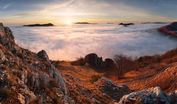 Panorama of sunset in a Carpathian mountain valley with wonderful gold light on a hills