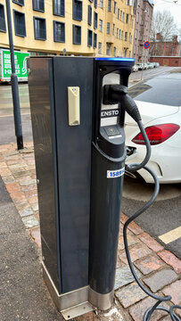 EV Charging Station on Brick Paved Street with Car