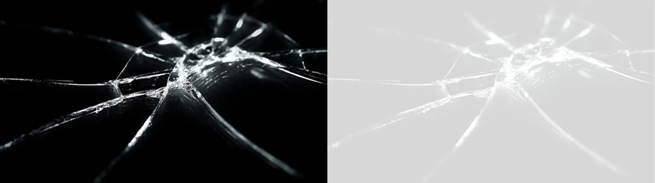 Real cracked glass texture overlay on black and transparent background. Shattered screen effect with impact fracture lines