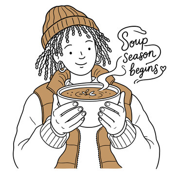 Young Black woman holding warm bowl of soup with steam rising  
