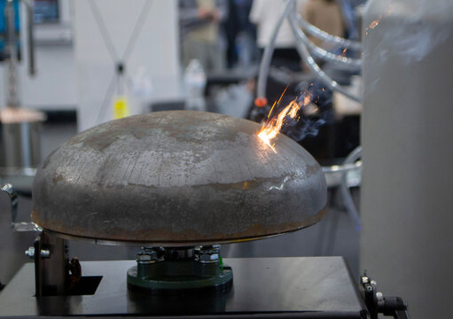Laser cleaning of metal. Contactless removing rust oxides using focused laser beam. Laser with sparks cleaning of metal surfaces. Laser cleaning metal from rust. Glowing beam clearing metal from dirt.