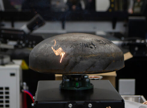 Laser cleaning of metal. Contactless removing rust oxides using focused laser beam. Laser with sparks cleaning of metal surfaces. Laser cleaning metal from rust. Glowing beam clearing metal from dirt.