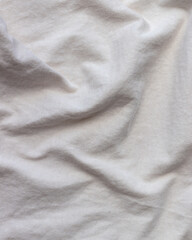 Fototapeta premium Soft white fabric texture with gentle folds, versatile minimalist background
