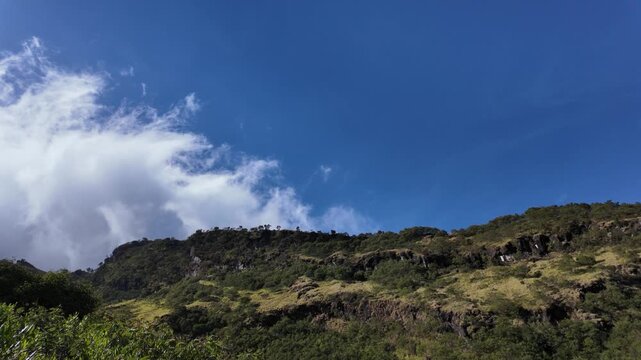 4k video footage of Views of Mount Sumbing ridge with volcanic cliff rocks, Wonosobo, Indonesia with blue sky in the morning.
