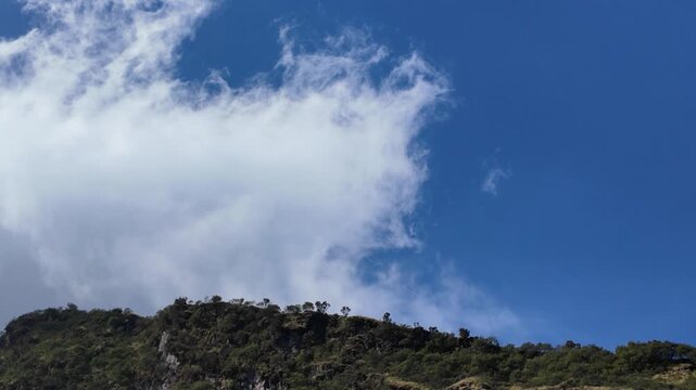 4k video footage of Views of Mount Sumbing ridge with volcanic cliff rocks, Wonosobo, Indonesia with blue sky in the morning.