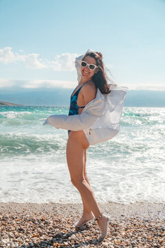 Woman in blue swimsuit by Adriatic sea