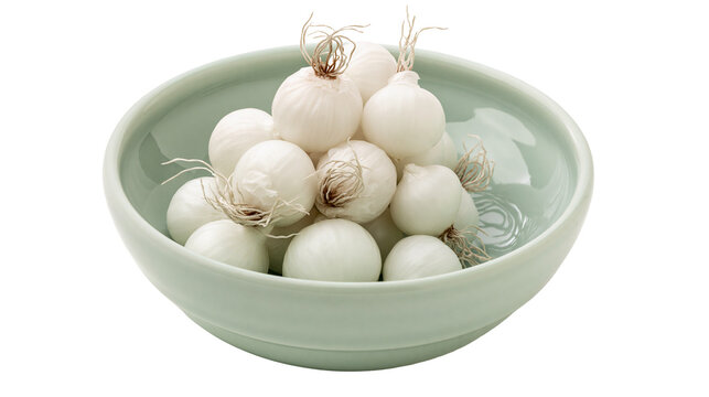 Pile of small white pearl onions in a pale green ceramic bowl, isolated on transparent background