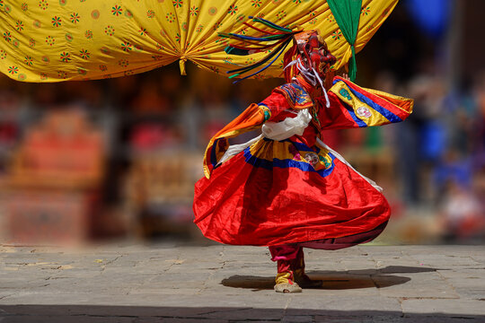 Bhutan, In the village of Bumthang, monks in colorful costumes dance during the annual Jakar festival. blurred background