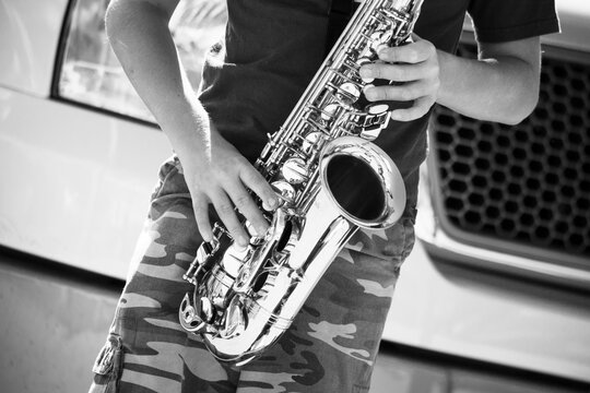 street musician playing saxophone black and white