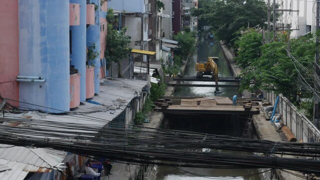 Excavator Dredging Urban Canal Bangkok Construction Public Infrastructure Maintenance Waterway Cleaning City Buildings Backdrop Footage Aerial View