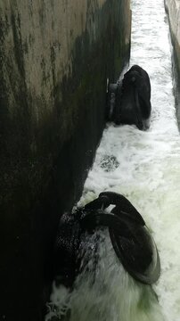 Iron Sluice Valve with Powerful Green Water Splash Close-Up
