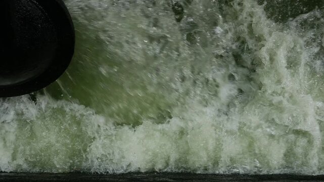 Iron Sluice Valve with Powerful Green Water Splash Close-Up