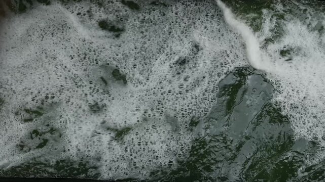 Rushing Turbulent River Water with White Foam Splashing Fast Current Motion