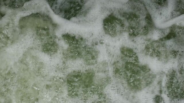 Rushing Turbulent River Water with White Foam Splashing Fast Current Motion