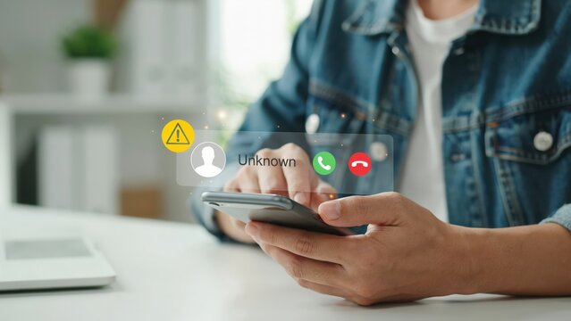 Person holding a smartphone receiving an incoming call from an unknown number