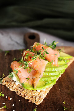 Crunchy crispbread topped with smoked salmon, avocado, and cress microgreens.