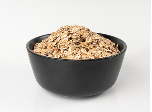 Spelt flakes isolated, dry raw rolled flat oat grains, wheat, oatmeal or bran, barley rye cereals