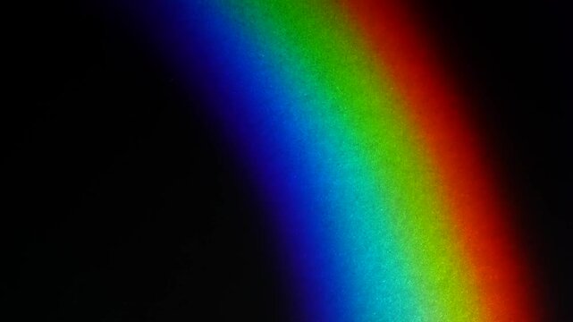 A diagonal rainbow spectrum glows across a black background with vivid blue, green and red bands. Concept digital design for advertising, banners, websites and editorial layouts.