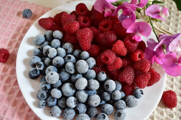 top view of a plate with frozen blueberries and strawberries © NADEZHDA RYBAK
