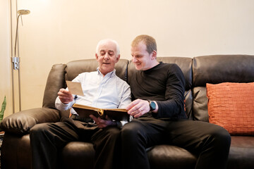 Fototapeta premium Generations bonding looking through family history album