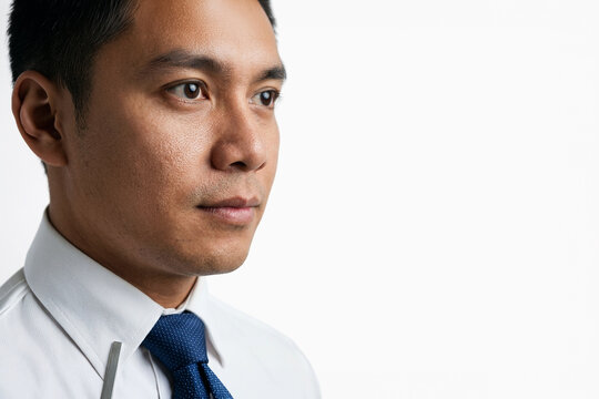 Professional man in white shirt and blue tie looking away