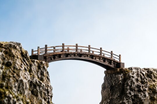 Miniature bridge model connecting two cliffs symbolic concept of connection and unity