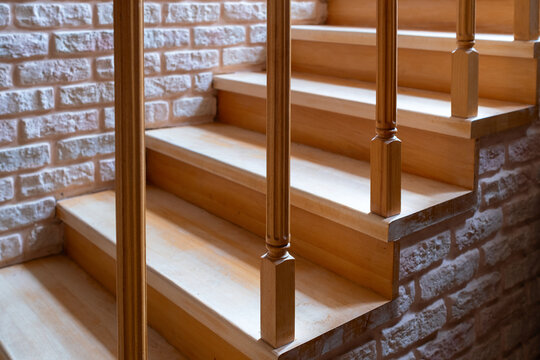 Wooden Staircase with Decorative Brick Wall in Modern Interior