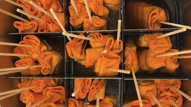 Spicy odeng: flattened minced fish paste skewered in a wavy pattern and served in a savory broth. Korean specialties
