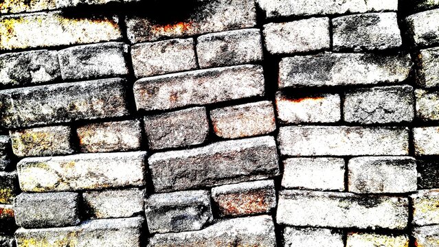 High contrast abstract texture of stacked old weathered bricks wall background with high gritty grain.