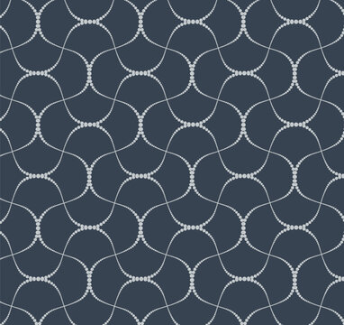 Seamless vector pattern of delicate dotted wavy lines forming an abstract geometric mesh on a dark charcoal blue background. Elegant tile for textile and wallpaper.